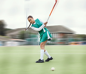 Image showing Hockey, sports or woman in a training game, tournament or competition with ball, stick or action on turf. Blur, strong or fit girl player in exercise, workout or motion on artificial grass for power