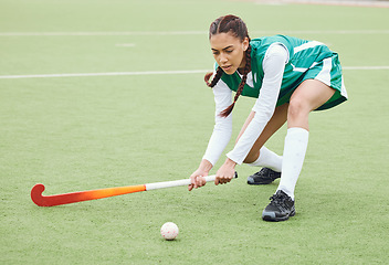 Image showing Hockey, sports or woman on turf in fitness training, game or competition with ball, stick or action. Strong, athlete or fit girl player in exercise, workout or motion on artificial grass for power