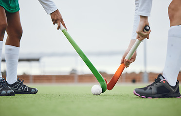 Image showing Fitness, hockey and women with sticks and ball on field for training, competition or challenge outdoor. Sports, person and legs on grass with workout, battle or exercise for wellness in nature