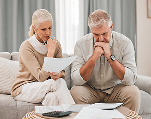 Image showing Man, woman and worried with documents for retirement, financial planning or budget. Mature, couple and family with paperwork, savings or calculating for future, discussion and together in living room