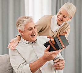 Image showing Happy couple, together and surprise with gift at house for retirement, birthday or anniversary on vacation. Elderly, man and woman in celebration of event with happiness, love and care for partner