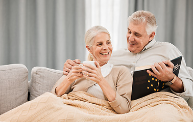 Image showing Senior, couple coffee and reading book on a living room sofa with love, smile and retirement in a home. Elderly people, story and lounge on couch with study for knowledge in a house happy and relax