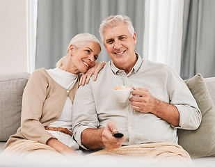 Image showing Old couple, home and watching tv with coffee and happiness together in retirement, partner and remote control. Love, care and online streaming, tv show with tea and people relax on couch for movie