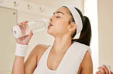 Image showing Fitness, drinking and woman with a water bottle for tennis practice, training or workout. Sports, exercise and young female athlete enjoying a healthy beverage for hydration for a game or match.