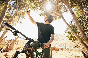 Image showing Bicycle, selfie and man with fitness, outdoor and social media with exercise, post and lens flare. Person, athlete and biker with photography, cycling and workout with influencer, sports or internet