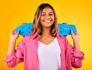 Image showing Woman, portrait and smiling with skateboard on yellow studio background, skater and excited. Cool, gen z face and happiness to skate, play and enjoy free time, in fashion clothes, outfit and stylish