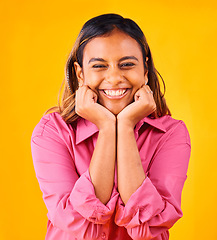 Image showing Woman, smile and happy with hands on face, portrait and closeup in studio with yellow background. Indian girl, self love and positive, satisfaction and confidence with hand gesture, style and fashion