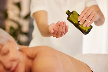 Image showing Massage, oil and a therapist with a woman at a spa to relax with wellness and skincare service. Hands, bottle and a masseuse with stress relief treatment for a patient body or person at a hotel