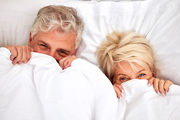 Image showing Hiding, portrait and a senior couple in bed for comfort, sleep or love in retirement. Shy, intimate and an elderly man and woman in the bedroom of a house with a blanket covering head in marriage