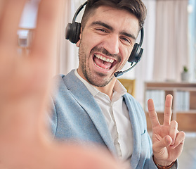 Image showing Portrait, selfie or happy man in a call center office on a break to post a photograph on social media online. CRM, peace sign or male sales agent taking fun pictures to relax in workplace with smile