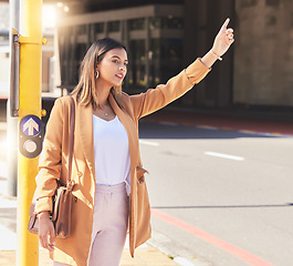 Image showing Wave, taxi and woman in city for cab, transportation and commute travel in cbd for business or meeting. Person, hand and sign to call attention of taxicab driver and passenger service in town