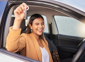 Image showing Portrait, car and woman with a key, smile and celebration with achievement, goals and success. Face, wink and happy girl with transportation, commute and new vehicle with travel, safety and road trip