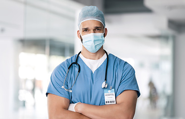 Image showing Portrait of man, surgeon in hospital with mask and ppe, healthcare worker with confidence and medicine. Health expert, medical professional and face of doctor in clinic with arms crossed in safety.