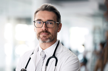 Image showing Serious doctor, portrait and man with glasses in hospital for health, wellness or career in medicine. Face, medical professional and confident surgeon, expert therapist or mature physician in Canada