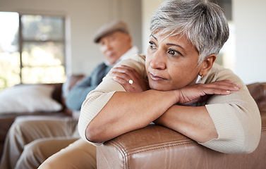 Image showing Divorce, stress and senior couple on a sofa fight, argue and angry at home together. Marriage, doubt and elderly woman thinking in living room with debt, fear or anxiety while ignoring toxic partner