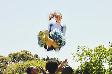 Image showing Fitness, energy and woman cheerleader on a field for motivation or support practice with team. Sports, cheerleading and female athlete training in air and dance with blur motion at competition.