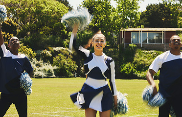 Image showing Cheerleader, team and people dancing on sports field at university, uniform and props with performance. Woman, men and diversity with teamwork or training, collaboration and gymnastics with fitness