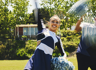 Image showing Cheerleader, lead dancer and hand raise in routine for university sport, game or fitness in uniform. Asian girl, energy and team with gymnastics, pom poms and college performance for competition