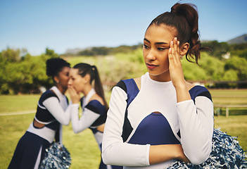 Image showing Bullying, cheerleader or friends with gossip about woman, talking behind back and secret on field. School, sports or students speaking of a sad girl teenager with rumor, problem or conversation