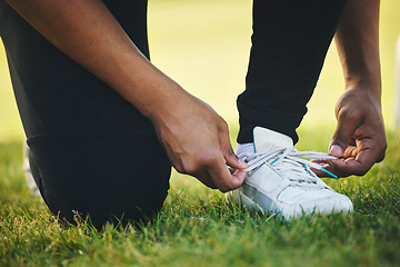 Image showing Person, hand and shoes for competition in sports on field for workout, practice or game in closeup. Athlete, dedication or tie lace on track for race by commitment in tournament, performance or match