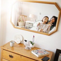 Image showing Happy lesbian couple in bedroom with mirror, peace sign icon and relax together in apartment. Queer love, smile and reflection of lgbt women on bed with emoji hand gesture, trust and support in home.