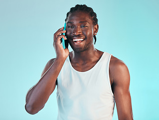 Image showing Happy, phone call and man in studio with conversation, chat or networking on blue background. Smartphone, communication and face of African male model smile or contact, discussion or funny news