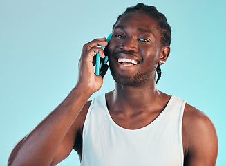 Image showing Phone call, communication and young black man in studio with smile for happy conversation. Technology, happiness and African male model on mobile discussion with cellphone isolated by blue background