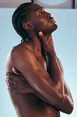 Image showing Body, black man and shirtless profile in studio with art, skincare and glow from skin wellness and confidence. Muscle, hug and male model creative with blue background and self care with strong arms