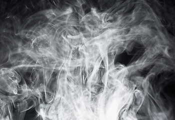 Image showing Smoke, steam or gas in a studio with dark background by mockup space for magic effect with abstract. Incense, fog or vapor mist moving in air for cloud smog pattern by black backdrop with mock up
