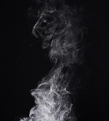 Image showing Incense, steam or gas in a studio with dark background by mockup space for magic effect with abstract. Fog, smoke or vapor mist moving in air for cloud smog pattern by black backdrop with mock up.