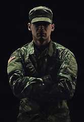 Image showing Soldier, man with arms crossed and army warrior in war, conflict and battle with uniform on black background. Hero, military and camouflage with security, protection and mission for fight in studio