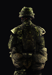 Image showing Soldier, man and army warrior in war, back view with conflict and battle in uniform on black background. Hero, military and camouflage with security, protection and mission for fight in studio