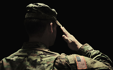Image showing Back, salute and army with a soldier in uniform on a dark background in studio for service or duty as a patriot. Military, respect and america marine or war veteran from behind, ready for battle