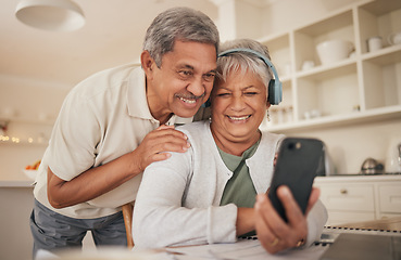 Image showing Phone, hug and senior couple with video call in a kitchen happy, headphones and communication. Love, smile and old people with smartphone app for virtual, conversation or contact chat in their house