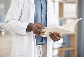 Image showing Doctor hands, paperwork and report in closeup for reading, analysis or study for wellness in hospital. Healthcare expert, medic and folder for documents, life insurance or check information in clinic