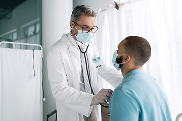 Image showing Doctor, stethoscope and patient in face mask for cardiology exam, healthcare service and virus check in hospital. Medical professional listening to man heart, breathing or support in clinic for covid