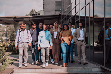 Image showing A diverse group of businessmen and colleagues walking together by their workplace, showcasing collaboration and teamwork in the company.