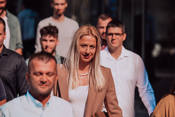 Image showing A diverse group of businessmen and colleagues walking together by their workplace, showcasing collaboration and teamwork in the company.