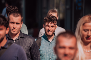 Image showing A diverse group of businessmen and colleagues walking together by their workplace, showcasing collaboration and teamwork in the company.