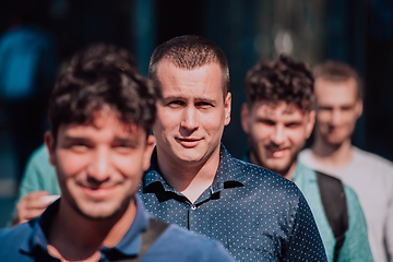 Image showing A diverse group of businessmen and colleagues walking together by their workplace, showcasing collaboration and teamwork in the company.