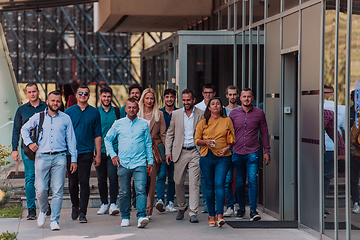 Image showing A diverse group of businessmen and colleagues walking together by their workplace, showcasing collaboration and teamwork in the company.