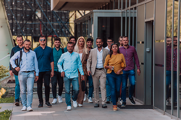 Image showing A diverse group of businessmen and colleagues walking together by their workplace, showcasing collaboration and teamwork in the company.