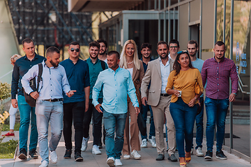 Image showing A diverse group of businessmen and colleagues walking together by their workplace, showcasing collaboration and teamwork in the company.