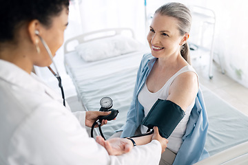 Image showing Doctor, patient and blood pressure for medical appointment, checkup or visit at hospital. Happy woman, surgeon or nurse helping customer or client for monitoring heart rate at healthcare clinic