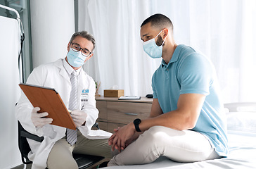 Image showing Doctor, patient and tablet with face mask in healthcare consultation for charts, test results or online advice. Medical professional and man on digital tech for hospital or clinic support with virus