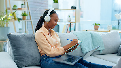 Image showing Video call, laptop and black woman doing remote work on couch in a home writing notes in webinar or e learning. Sofa, information and student working with online technology in apartment for research