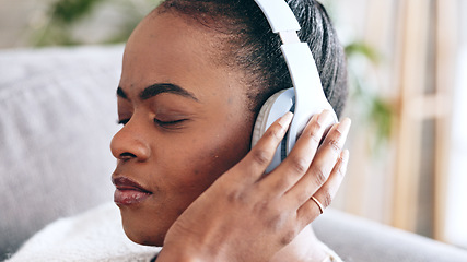 Image showing Black woman, headphones and peace with meditation and relax on couch at home, wellness and stress relief with podcast. Music, audio streaming and face with calm, wireless technology and mindfulness