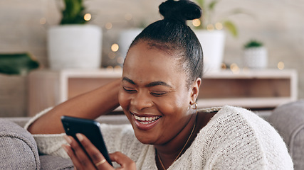 Image showing Funny, black woman and using phone with smile in home or social media, mobile app and communication online. internet, meme or person on couch streaming video or comedy on cellphone in living room