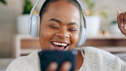 Image showing Black woman, headphones and music with smartphone and happiness, audio streaming and fun while at home. Listening to radio, sound and smile for playlist with energy, dancing and mobile app in lounge