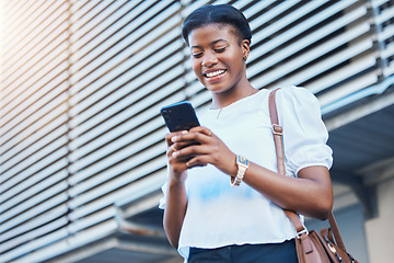 Image showing Cellphone, walking and young woman in the city networking on social media, mobile app or the internet. Happy, technology and African female person scroll on a phone and commuting in urban town street